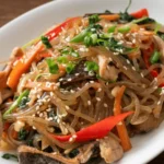 Japchae Noodles Recipe: Easy Korean Stir-Fried Glass Noodles.